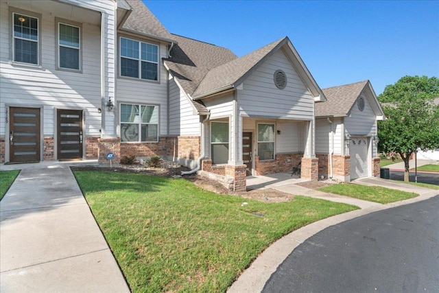12185 Chelsea Glen Place Br, Austin, TX 78753 - view of front of home featuring brick siding, a front yard, an attached garage, and roof with shingles