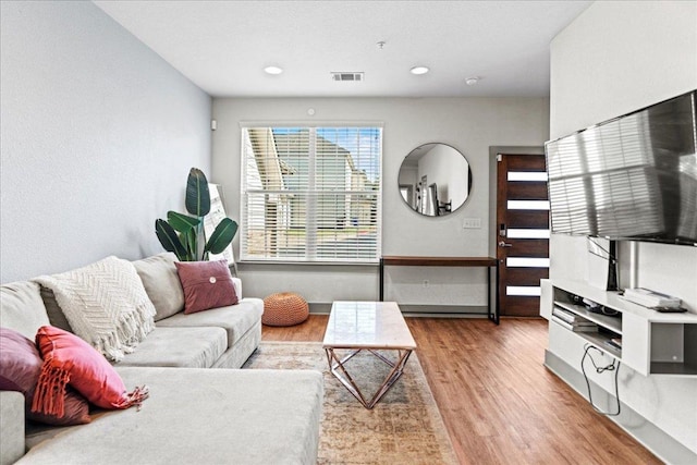living room featuring light wood-type flooring and recessed lighting