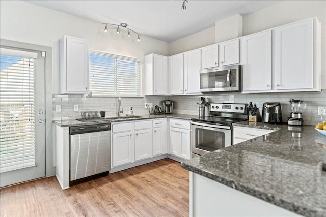 12185 Chelsea Glen Place Br, Austin, TX 78753 - kitchen featuring stainless steel appliances, plenty of natural light, and tasteful backsplash