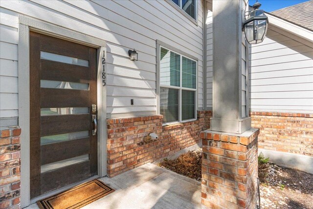 12185 Chelsea Glen Place Br, Austin, TX 78753 - doorway to property with brick siding