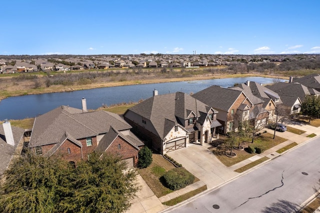 bird's eye view featuring a residential view and a water view