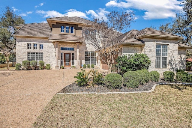 view of front facade featuring stone siding and a front lawn