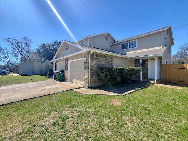 traditional-style home with a front yard, driveway, an attached garage, and fence