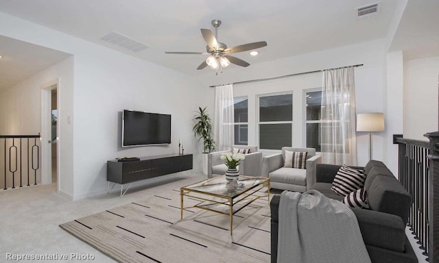 living room featuring visible vents, ceiling fan, and carpet flooring