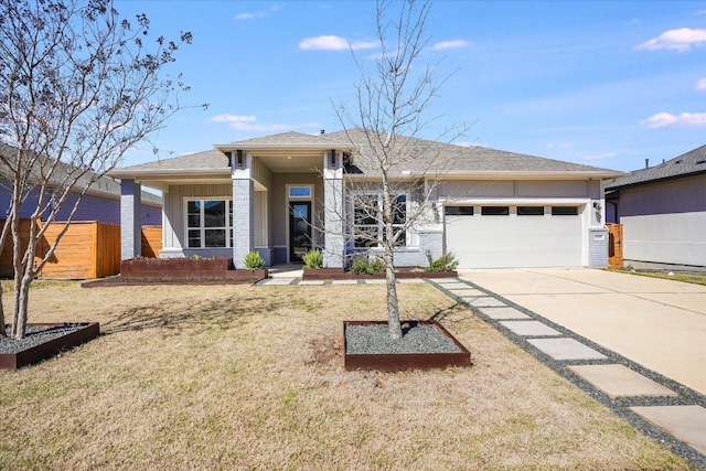 prairie-style home featuring driveway, a front lawn, and an attached garage