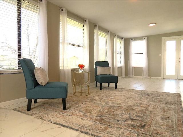 sitting room featuring french doors and baseboards