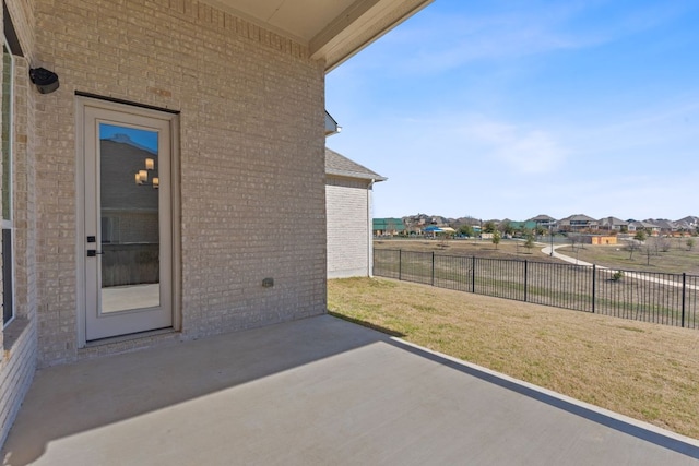 view of patio / terrace featuring fence and a residential view