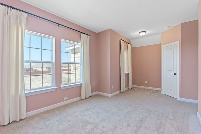 unfurnished bedroom featuring baseboards and light colored carpet