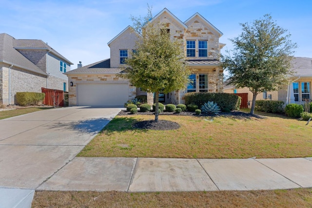 view of front facade with a front yard, a standing seam roof, metal roof, stone siding, and driveway