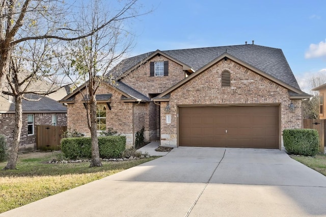 view of front of home with a shingled roof, brick siding, driveway, and a garage