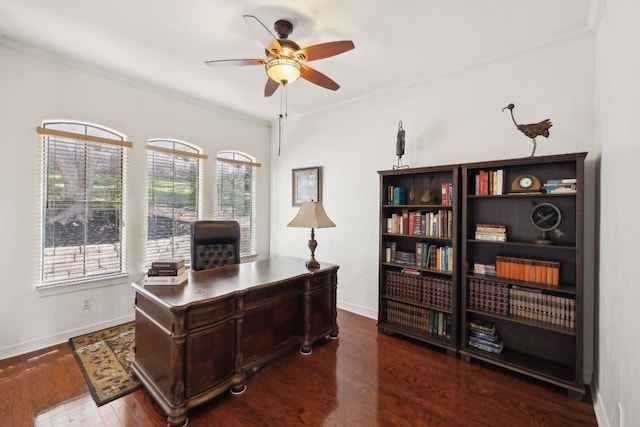 home office featuring baseboards, dark wood-type flooring, a ceiling fan, and crown molding