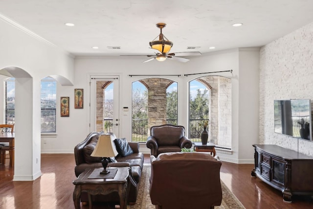 living room featuring wood finished floors, visible vents, and baseboards