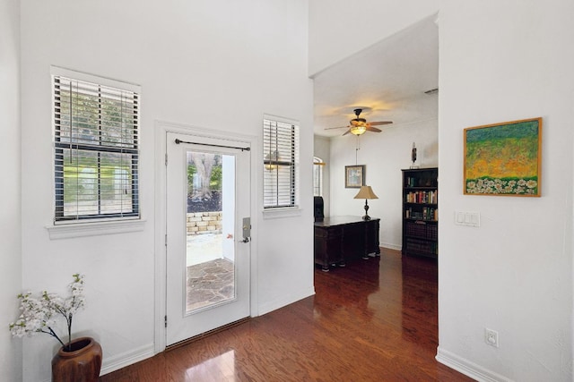 entryway featuring wood finished floors, a ceiling fan, and baseboards