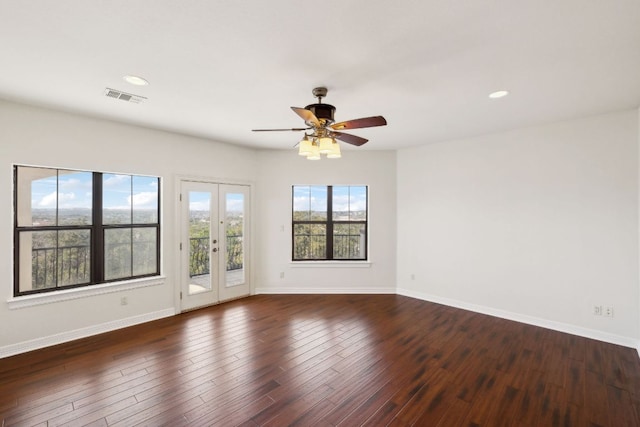 unfurnished room featuring french doors, wood-type flooring, visible vents, and baseboards