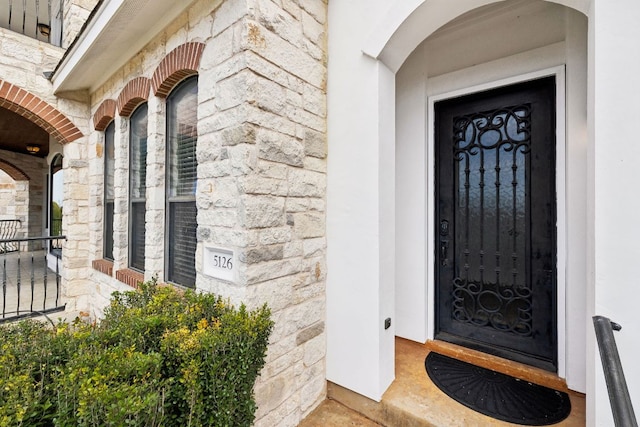 view of exterior entry featuring stone siding