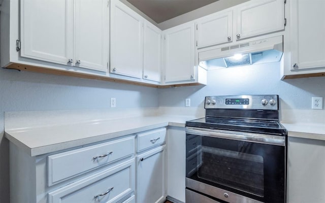 kitchen featuring white cabinetry, light countertops, stainless steel electric range, and under cabinet range hood