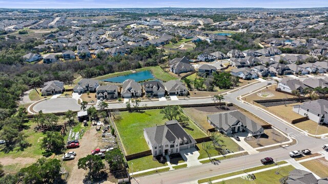 drone / aerial view featuring a residential view and a water view