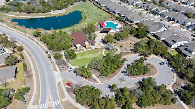 drone / aerial view with a water view and a residential view