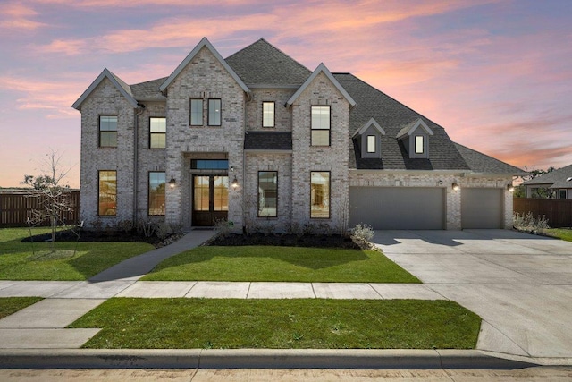 view of front of home featuring a garage, fence, a front lawn, and concrete driveway