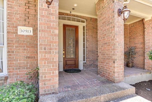 entrance to property with brick siding