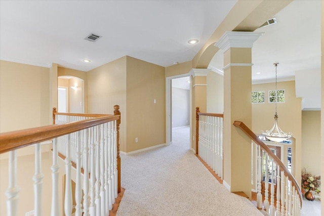 corridor featuring carpet floors, baseboards, visible vents, and an upstairs landing