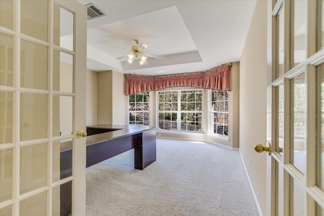 unfurnished office with carpet, visible vents, a tray ceiling, and french doors