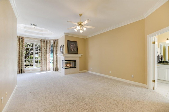 10513 Indigo Broom Loop, Austin, TX 78733 - unfurnished living room featuring crown molding, carpet, a fireplace with flush hearth, a ceiling fan, and a tray ceiling