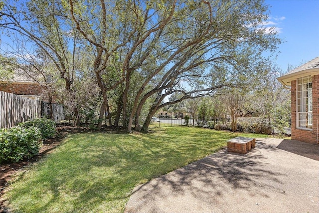 view of yard featuring a patio area and a fenced backyard