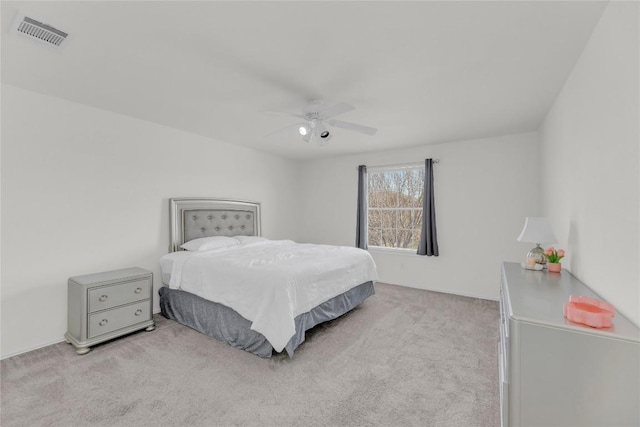 carpeted bedroom with visible vents and a ceiling fan