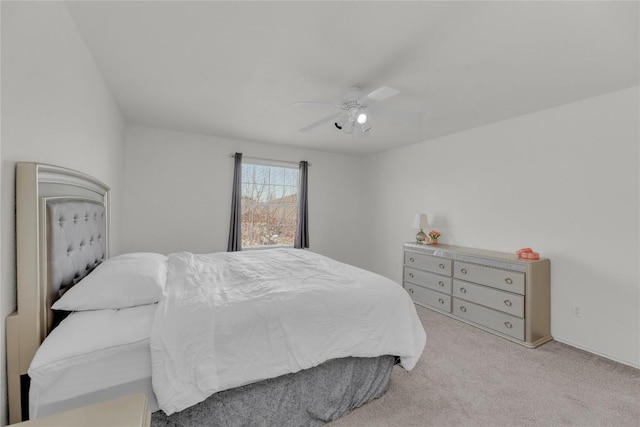 bedroom featuring light colored carpet and ceiling fan