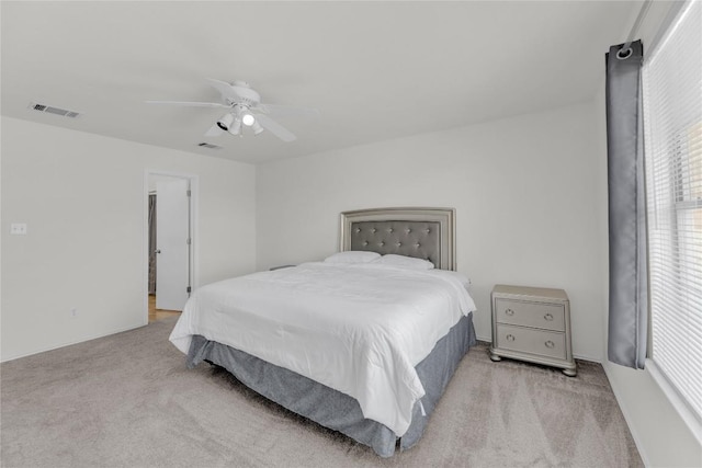 bedroom featuring a ceiling fan, light carpet, and visible vents