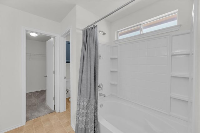 bathroom featuring toilet and shower / bath combo with shower curtain