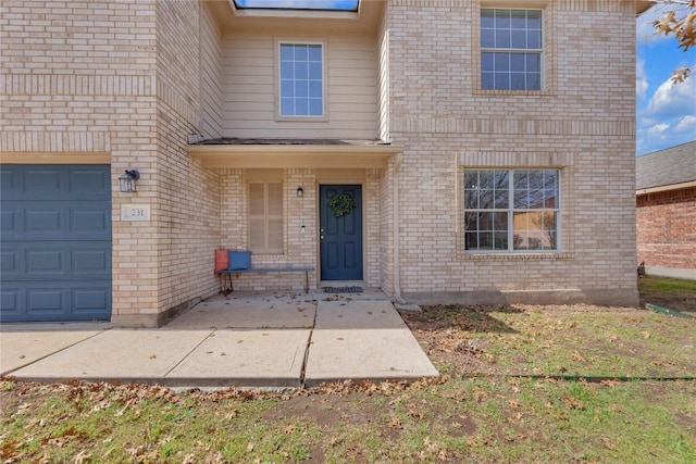 doorway to property with brick siding