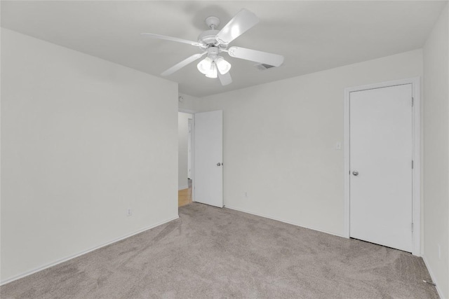 unfurnished bedroom featuring carpet floors, visible vents, and a ceiling fan