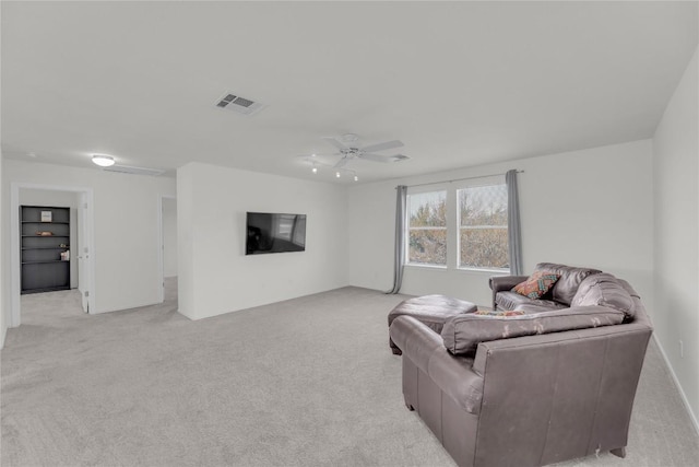 living room with a ceiling fan, light colored carpet, and visible vents