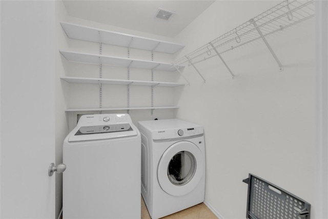 laundry room with laundry area, washer and clothes dryer, and visible vents