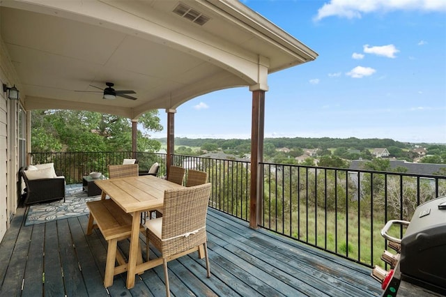 wooden deck with outdoor dining area, visible vents, ceiling fan, and area for grilling