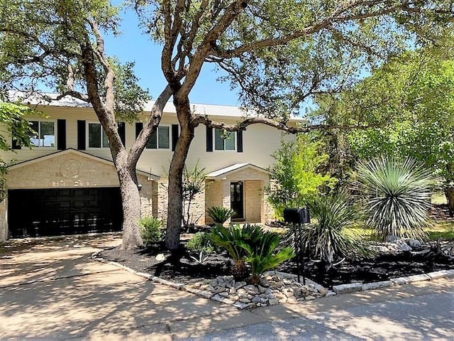 view of front facade featuring driveway, a garage, and stucco siding