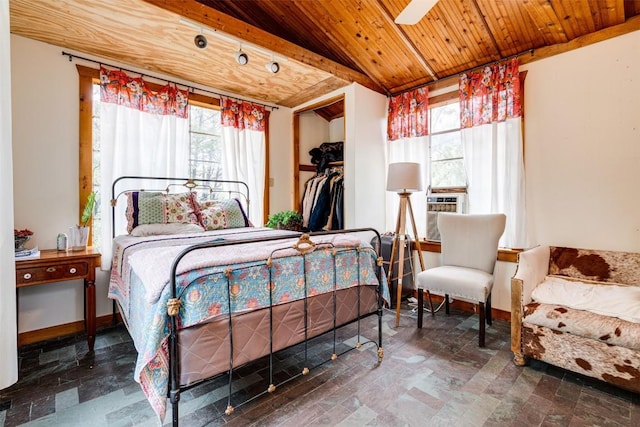 bedroom featuring wooden ceiling, stone finish flooring, and baseboards