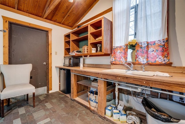 interior space with wood ceiling, vaulted ceiling, and a sink