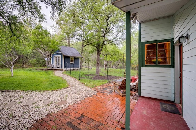 view of patio featuring an outbuilding