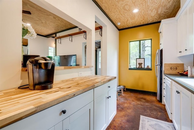 kitchen featuring butcher block counters, plenty of natural light, recessed lighting, and white cabinets