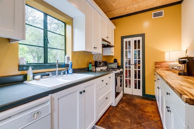 kitchen with under cabinet range hood, white appliances, a sink, white cabinetry, and wood counters