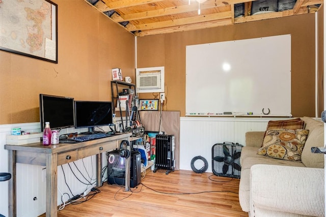 office space with wooden ceiling, wainscoting, beam ceiling, and wood finished floors