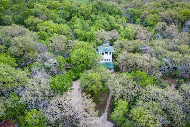 drone / aerial view with a wooded view