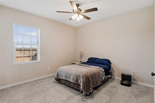 carpeted bedroom with ceiling fan and baseboards