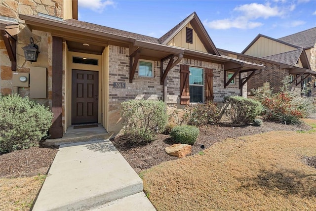 entrance to property featuring brick siding and board and batten siding