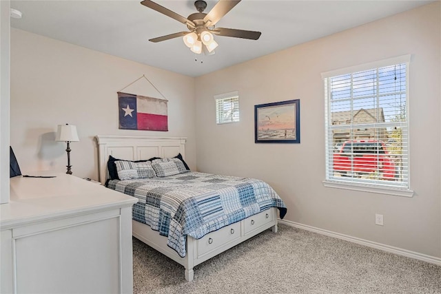 bedroom featuring baseboards, ceiling fan, and light colored carpet