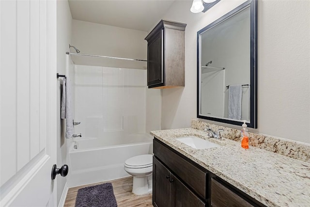 full bath featuring washtub / shower combination, vanity, toilet, and wood finished floors