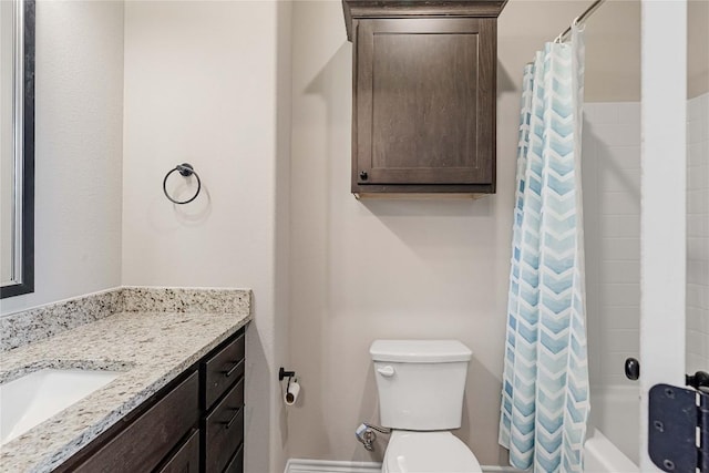 bathroom featuring toilet, vanity, and shower / tub combo with curtain